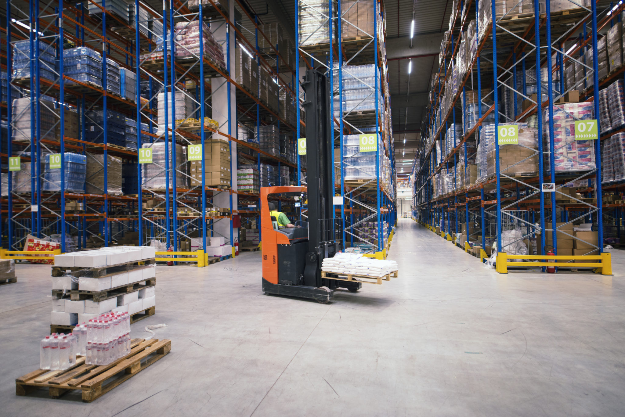industrial-building-large-warehouse-interior-with-forklift-and-palette-with-goods-and-shelves